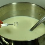 culture being added to top of milk in pot