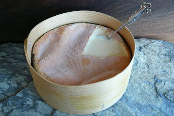 Vacherin Mont D'or cheese with spoon in top