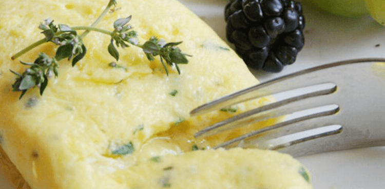 French omelet with comte cheese with fresh thyme on top