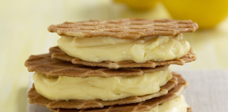 Stack of frozen lemon chevre cookie bites with lemon in the background