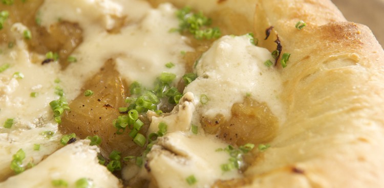 Extremely close up shot of pizza with cheese and chives