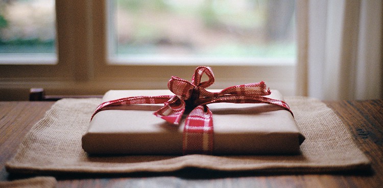 package with brown wrapping paper tied up with a plaid ribbon