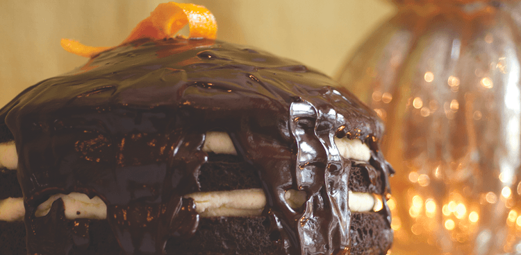 Layer cake with mascarpone filling and chocolate ganache frosting, topped with an orange peel