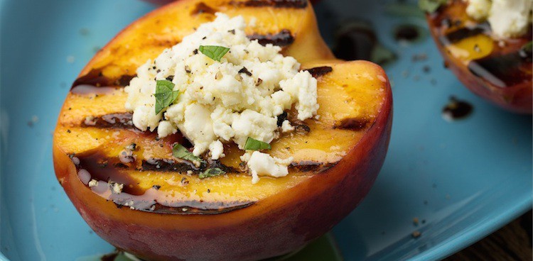 Grilled peach halves filled with creamy aged goat cheese and drizzled with olive oil and balsamic