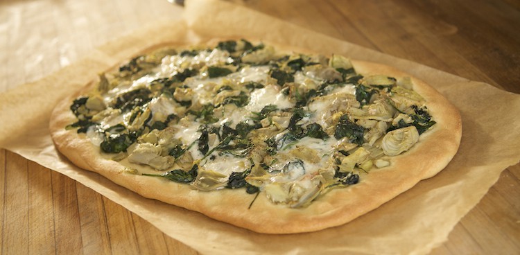 Green pizza with spinach, artichokes, and teleme cheese