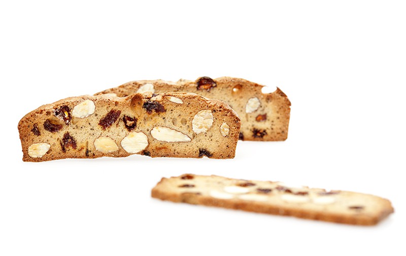Three biscotti-esque crackers are prominently displayed in an artsy, minimalist photo-shoot.