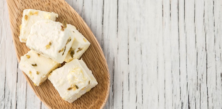 feta cubes with fennel pollen on a wooden spoon