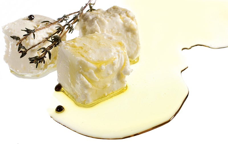 A few cubes of a white Mediterranean are drizzled with olive oil.