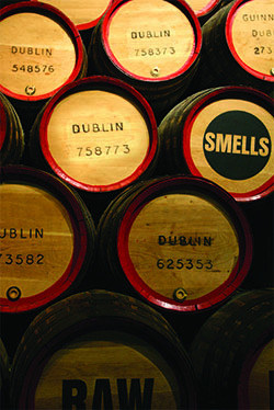 A wall of wooden beer barrels with labels such as "SMELLS" and "RAW"