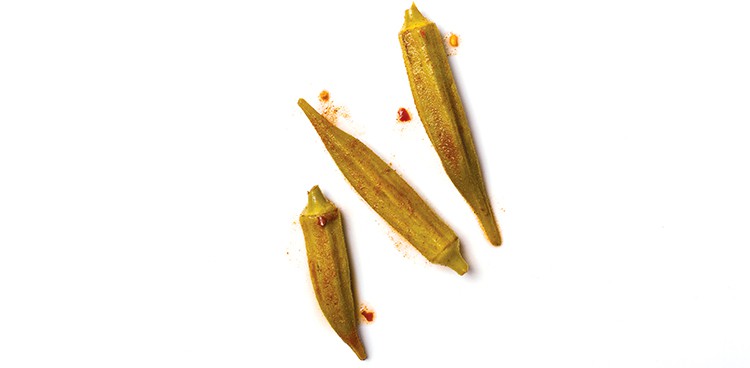 Rick's Picks Smokra: Three pieces of pickled okra with paprika on a white background