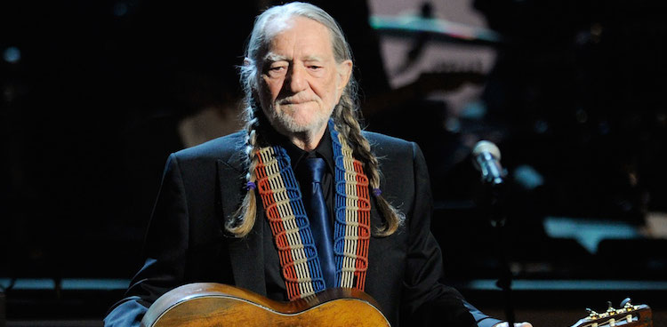 Willie Nelson with braids and guitar