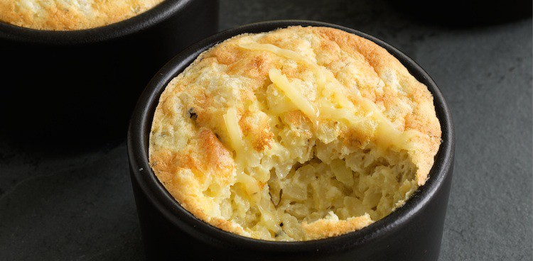 individual portion cheddar risotto souffles in black ramekins