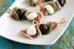 Creamy bocconcini (mini mozzarella balls), pickled sour cherries, herbacious basil, and salty prosciutto alternated on bamboo skewers