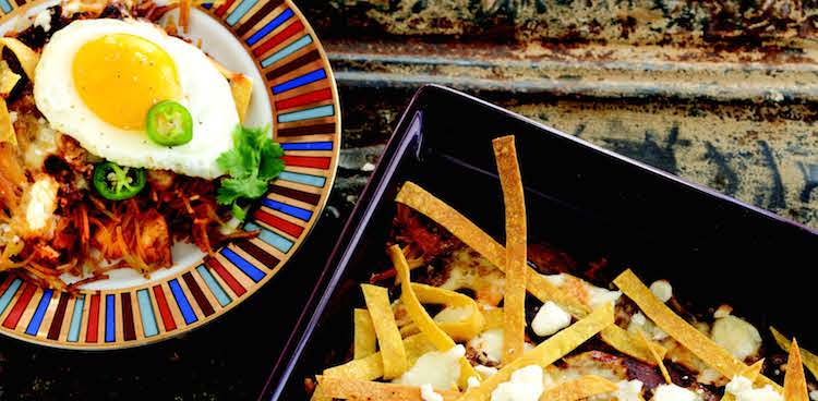 Tray of baked chilaquiles next to a plate of chilaquiles topped with a fried egg