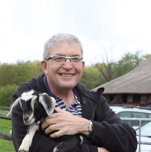 Cheesemonger Louis Risoli of L'Espalier holding a baby goat