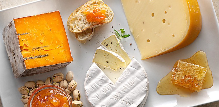 Cheese board featuring three Wisconsin cheeses