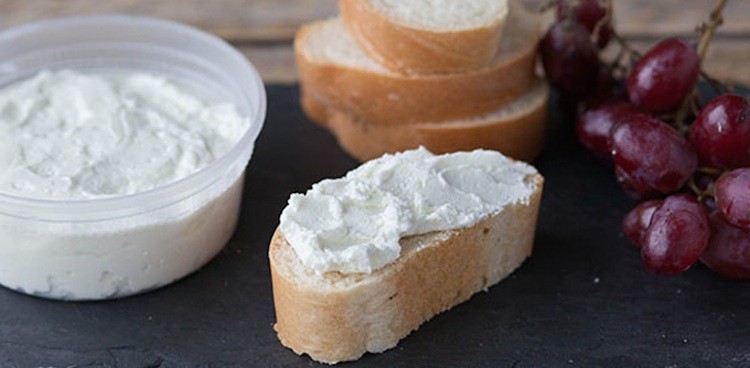 Fresh Goat Cheese, known as chévre, spread on a slice of baguette