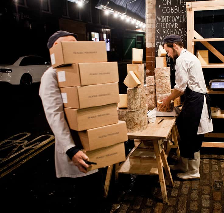 Stacking cheese-filled boxes for customers to pick up at Neal's Yard Dairy's Borough Market store (Photo by Piotr Malecki)