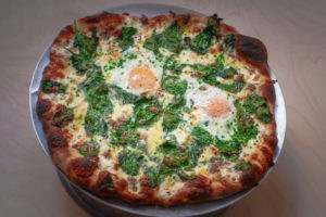 An egg-topped pie at Pizzeria Beddia. Photo Credit: David Fields.