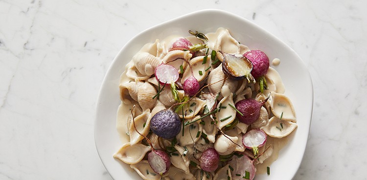 Whole wheat shells with tahini, radishes, and chives