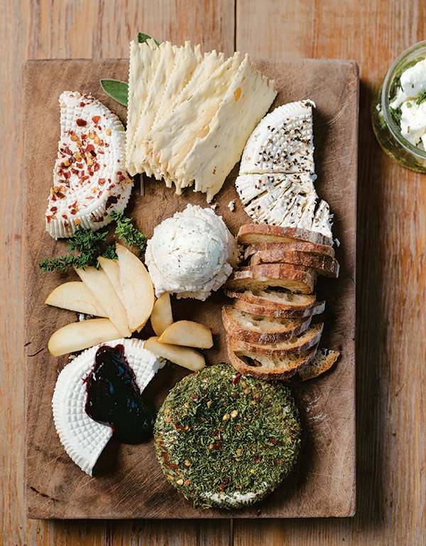 A sampling of the dairy's cheeses. Clockwise from top left: Anaheim Red Chili Chevre, Cracked Black Pepper Chevre, Feta, Mixed Herb Chevre, Plain Chevre, and June's Joy.