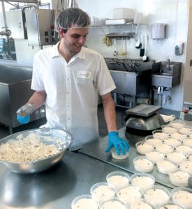 Fresh cheese is packaged at Clock Shadow Creamery in Milwaukee, Wis.