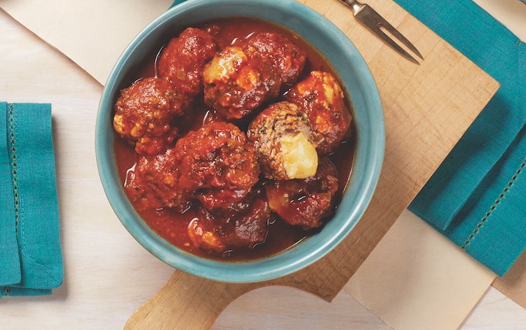 meatballs stuffed with cheese in a smokey tomato sauce