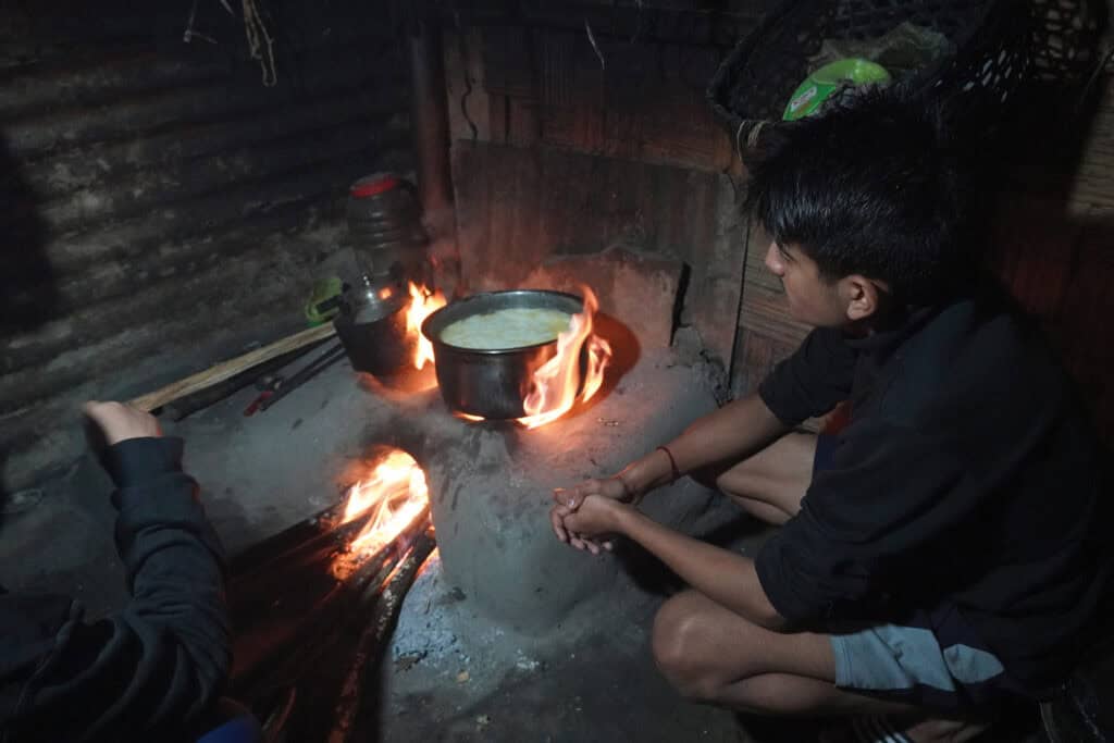 A man presides over a boiling pot of buttermilk.