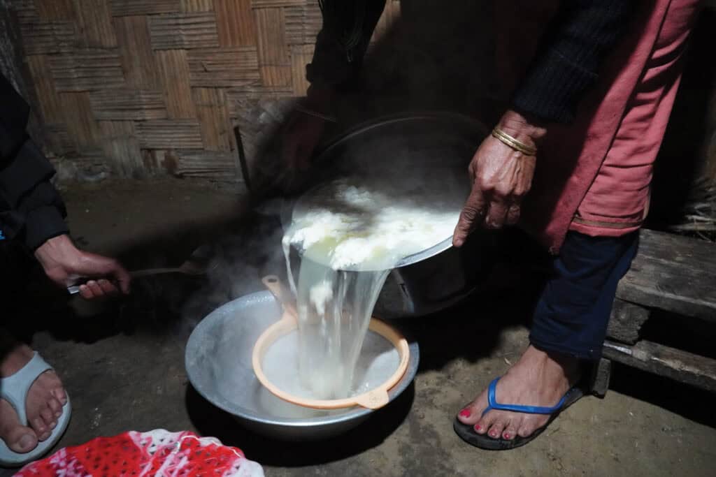 A woman pours fresh chhurpi and whey through a sieve in Sikkim, a Himalayan state where the cheese is popular.