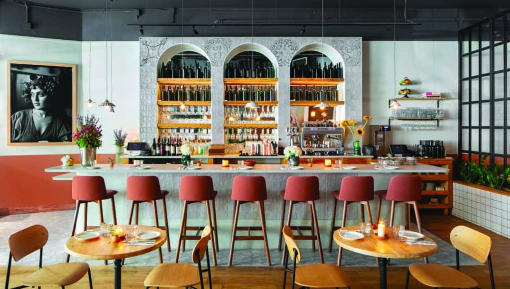 A bar with orange stools and decorated with Georgian flair.