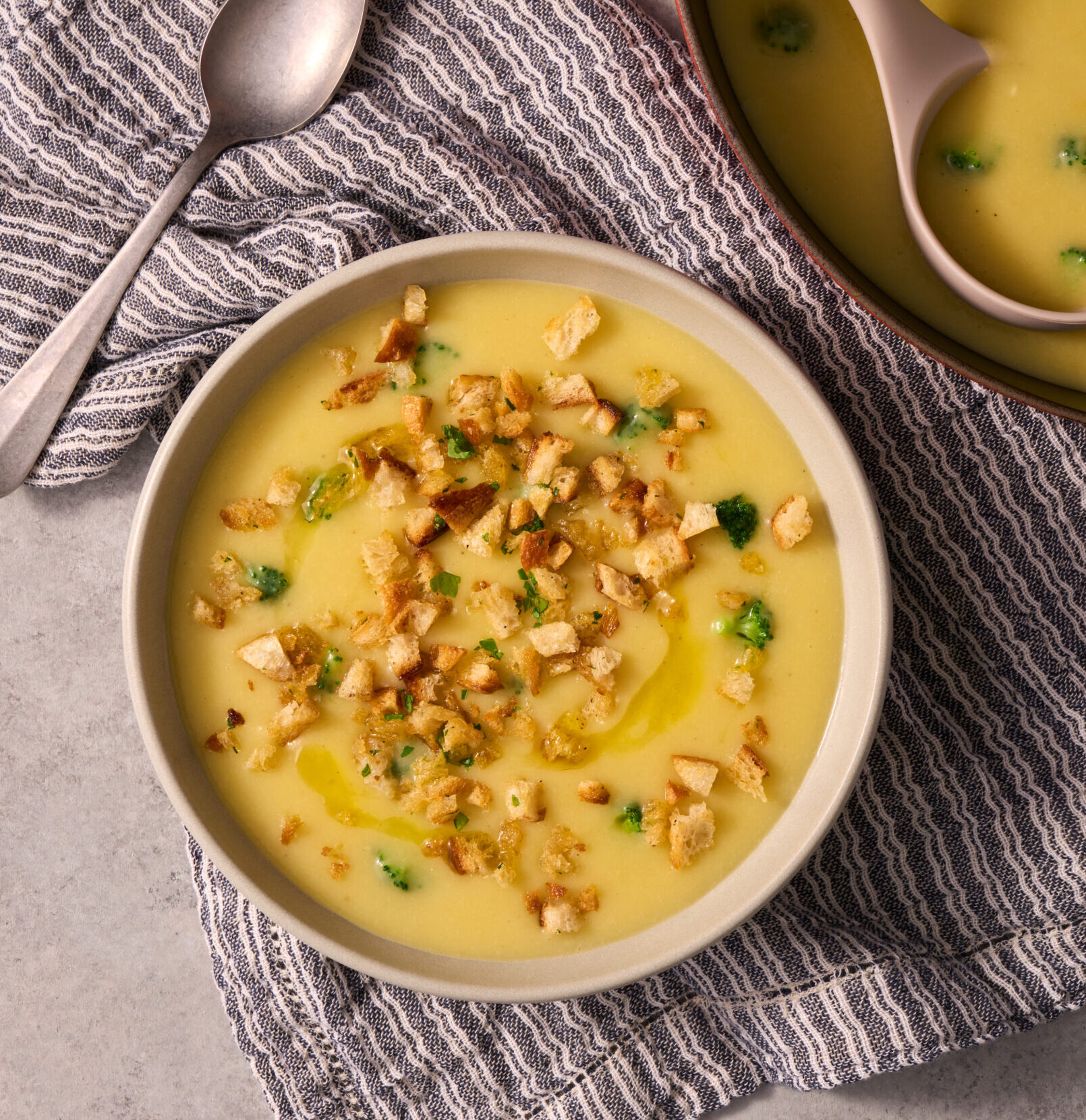 Potato, Leek, and Raclette Soup with Broccoli and Truffle Oil