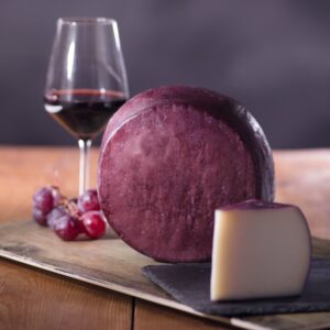 A red wine-soaked wheel of cheese.
